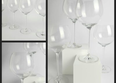 Wine glasses arranged on white cubes.