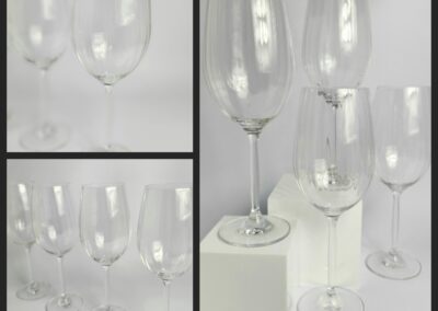 Four clear wine glasses, different angles.