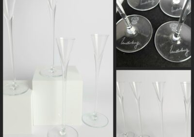 Tall elegant glass flutes with signed bases.
