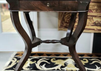 Antique wooden table with curved legs.