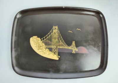 Black tray with golden bridge design.