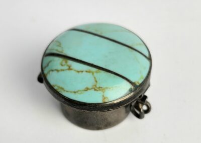 Turquoise stone metal clasp with stripes.