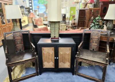 Vintage chairs and cabinet with table lamp.