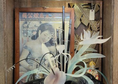 Decorative shelf display with artwork and ornaments.