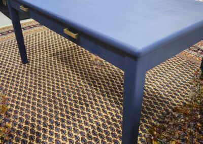 Blue table on patterned rug in store.