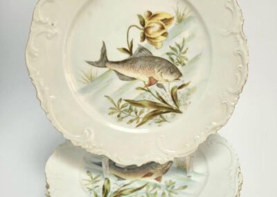 Decorative plates with fish and floral design.