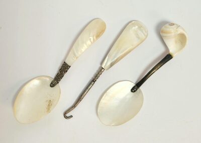 Three vintage mother-of-pearl spoons.
