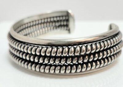 Silver cuff bracelet with beaded design.