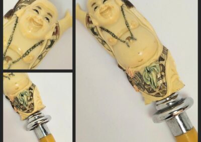 Smiling Buddha bottle stopper with ornate details.