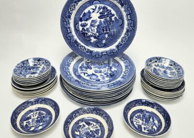 Blue and white porcelain dinnerware set displayed.
