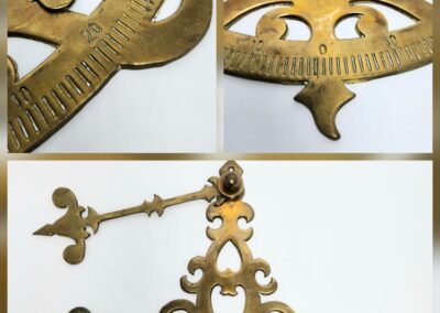 Antique brass protractor with decorative design.