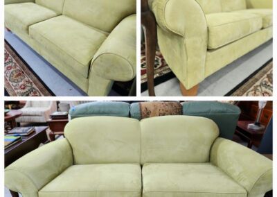 Green sofa with wooden legs, three angles.