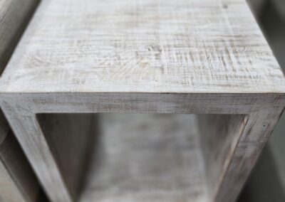 Rustic wooden cube-shaped side table.