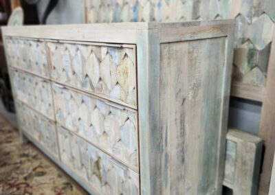 Rustic wooden dresser with geometric patterns.