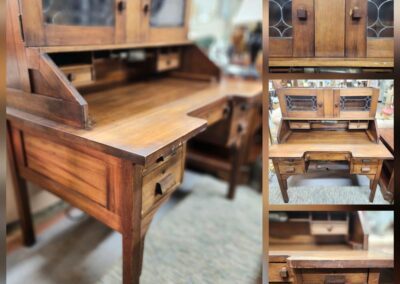 Antique wooden desk with glass cabinet doors.