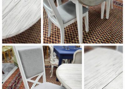 White wooden table and chairs on carpet.