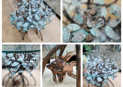 Glass table with metal leaf design.