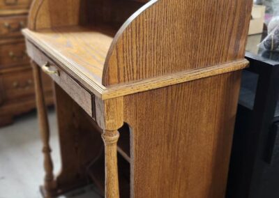 Wooden roll-top desk with shelves and drawers.