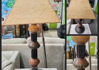 Decorative lamp with triangular beige shade.