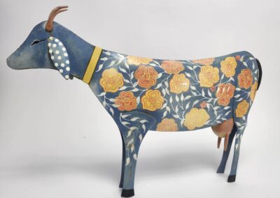 Colorful cow sculpture with floral patterns.