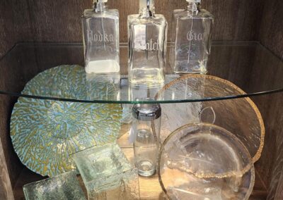 Glass bottles and decorative plates on display.