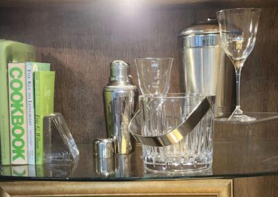 Bar shelf with glassware and cookbooks.