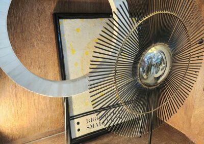 Abstract metal and marble circle sculptures.