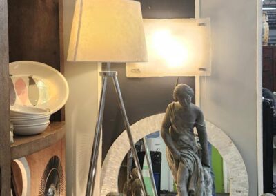 Decorative statue fountain with lamp and artwork.