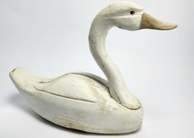 Carved wooden swan on white background.