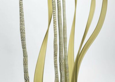 Abstract golden sculpture with tall, wavy forms.