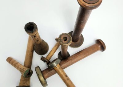 Wooden vintage industrial bobbins on white background.