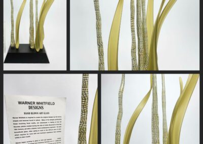 Yellow abstract sculpture with informational sign.