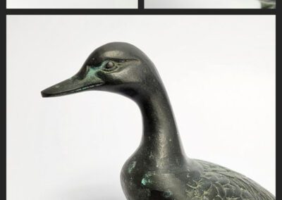 Bronze duck sculpture in three different views.