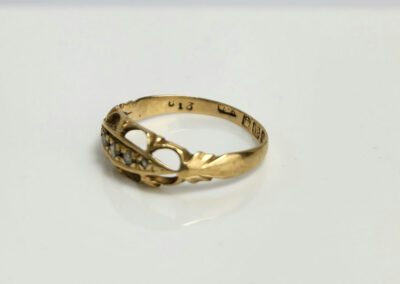Gold ring with diamond accents on display.