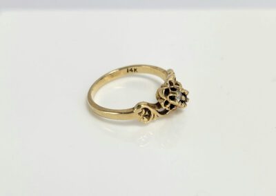 14K gold ring with intricate design.