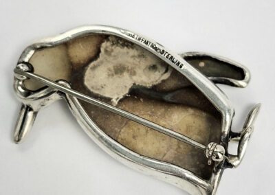 Back view of silver penguin brooch pin.