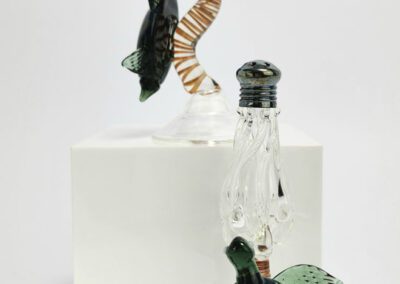 Glass bottles with turtle decorations displayed.