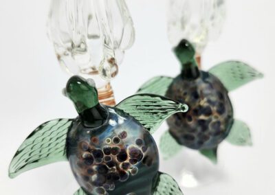 Glass turtle sculptures with intricate details.