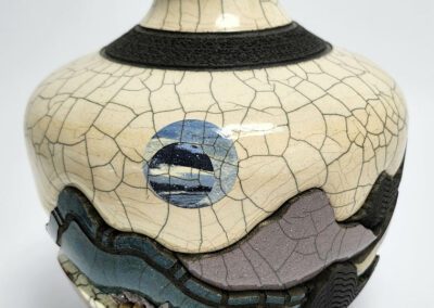 Ceramic vase with abstract landscape design.
