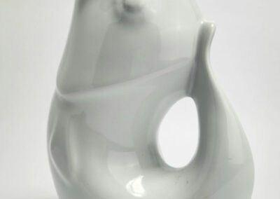White ceramic animal-shaped pitcher on display.
