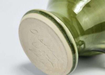 Green ceramic vase with engraved base.