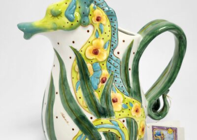 Colorful ceramic pitcher with seahorse design.