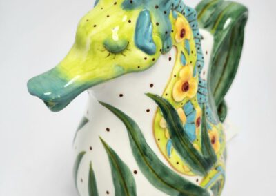 Colorful ceramic seahorse with floral design.