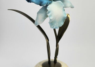 Blue and white flower sculpture in vase.