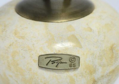 Marble base with engraved metal plaque.