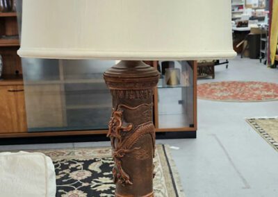 Ornate table lamp with white shade.