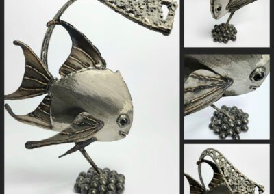 Metallic fish sculpture with detailed fins.