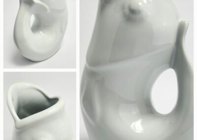 White ceramic fish-shaped water jug.