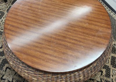 Round wooden table with woven sides.