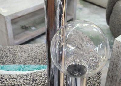 Glass spheres on metallic poles in room.